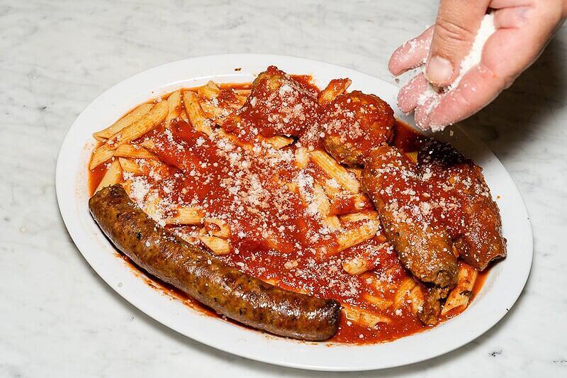 Sunday Feast · Homemade braciole, sausage and 2 meatballs. Served over penne pasta.