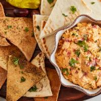 Spicy Pimento Cheese · Grated sharp cheddar, mayo, diced red peppers and a hint of Tabasco, served with soft or bak...