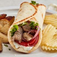Grilled Beef Tender Gyro · Taziki sauce, tomatoes, mixed lettuce and grilled onions. Served with chips.