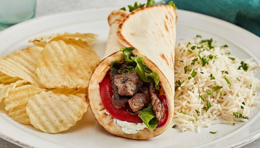 Grilled Lamb Gyro · Taziki sauce, tomatoes, mixed lettuce and grilled onions.