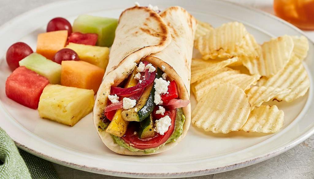 Grilled Veggie Gyro · Pesto aioli, tomatoes, with grilled zucchini, squash, onion, roasted red peppers and feta. Vegetarian.
