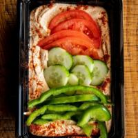 Hummus with Veggies · Tomato, cucumbers, green peppers, puree of chickpeas and spices garnished with paprika and p...