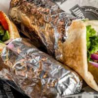 Beef Shawarma · Grilled marinated beef, tomato, lettuce, pickles, onions, garlic spread, wrapped in a pita.