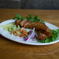 Thai Herb Sausage · Roasted Thai Northern style herb sausage, with peanut, cut ginger, sliced red onion, lemon a...