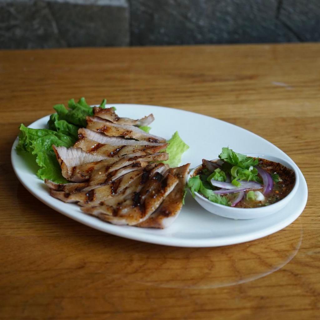Grilled Pork Shoulder · Smoky and tasty! Grilled slices of pork shoulder with chili and rice powder sauce.