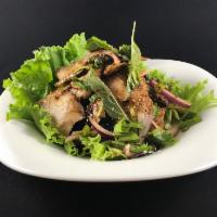 Grilled Pork Shoulder Salad · Spicy lime dressing and roasted quick marinated pork shoulder, basil leaves, chili, and rice...