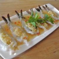 Raw Shrimp Salad · Fresh raw prawns with chili and lemongrass in lime-based dressing. Served with sliced garlic...