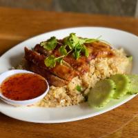 Crispy Chicken over Fried Rice · Crispy chicken over fried rice served with sweet chili sauce.
