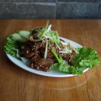 Black Pepper Beef · Stir-fried top sirloin beef with Thai black peppers, yellow onions, and green onions.