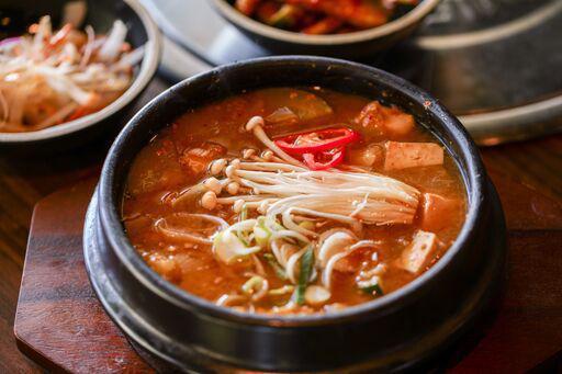 DOENJANG JJIGAE · Soybean paste stew with pork, tofu and vegetables.