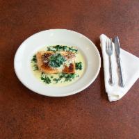Salmon Florentine · Salmon over a bed of spinach in a creamy garlic sauce.