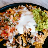 Nachos · Tortilla Chips, Beans, Choice of any Meat, Melted Mozzarella, Topped with Pico de Gallo, Sou...