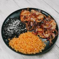 Pork Loins Plate · Pork Chops and Grilled Onions Served with Rice, Beans and Tortillas.