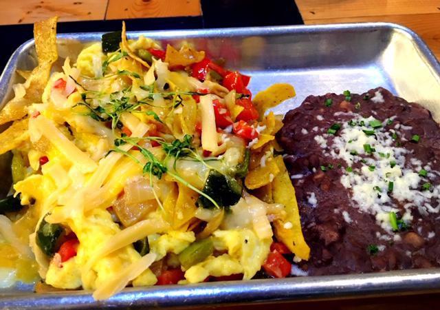 Chilaquiles Amigos! · Eggs scrambled with assorted cheeses, mixed peppers, onions, tortillas, & green cilantro sauce with a side of black beans.