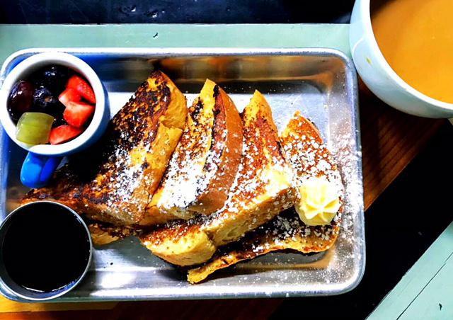 French My Toast · golden-brown french toast with whipped honey butter & maple syrup & served with fruit.