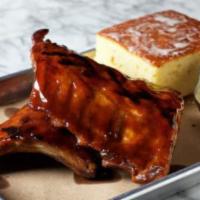 BBQ Baby Back Ribs · 18-hour pork ribs served with coleslaw and cornbread + honey butter
