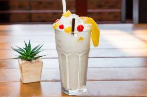 Piña Colada Milkshake · Fresh pineapples, vanilla ice cream, coco lopez, whipped cream, cherries.