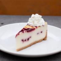 raspberry white chocolate cheesecake slice · raspberry sauce, whipped cream, graham cracker crust