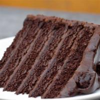 Ginormous Chocolate Cake Slice · Colossal! silky chocolate filling, whipped cream, chocolate chunks.