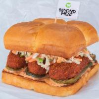 Beyond® The Hot Chick · Nashville-style fried or grilled Beyond® tenders, secret sauce, dill pickle slices and haus ...