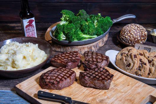 Steak Family Meal · Four 8 oz. top sirloin center-cut, home-style mashed potatoes or 5-grain rice pilaf, fresh broccoli with garlic butter, and eight chocolate chip cookies. *All steaks cooked to the same temp. 