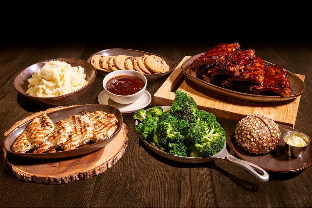 BBQ Family Meal · 4 fire-grilled chicken breasts smothered in our smoky molasses bbq sauce, bbq baby back ribs, choice of home-style mashed potatoes or 5-grain rice pilaf, fresh broccoli with garlic butter, 8 chocolate chip cookies. Additional side of our smoky molasses bbq sauce included.