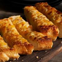 Three Cheese Garlic Bread · French bread topped with fresh garlic and a hot blend of Cheddar, Jack and Parmesan cheeses.