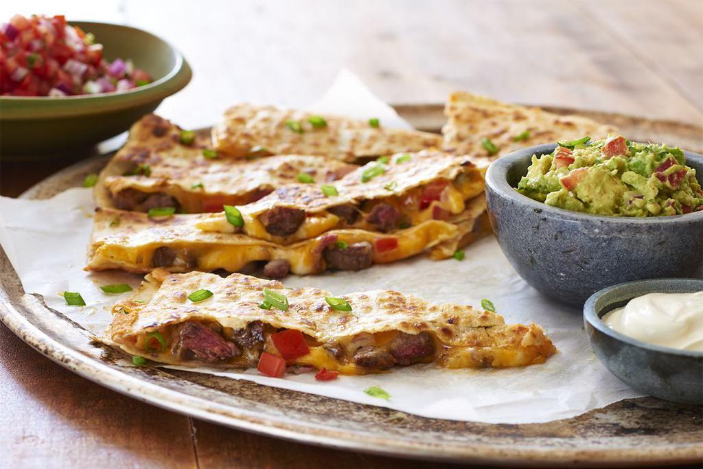 Steak Quesadilla · Filled with seasoned grilled steak, fresh pico de gallo, and cheddar and jack cheeses. Served with guacamole and sour cream.