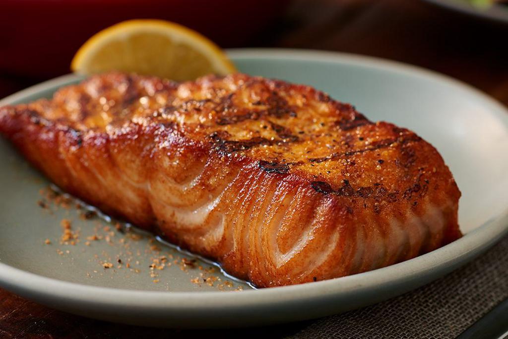 Grilled Fresh Salmon · A 8 oz. filet of fresh salmon, hand-cut, simply seasoned and grilled over an open flame.