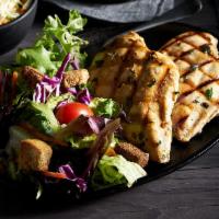Fire-Grilled Chicken Breast · Two chicken breasts lightly marinated with fresh garlic, sage, parsley, thyme, and lemon.