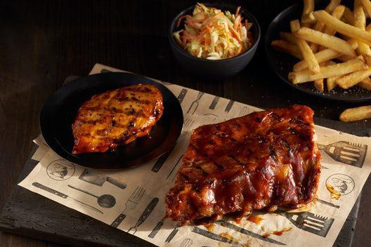 BBQ Chicken & Ribs · A grilled chicken breast and a half rack of baby back ribs both smothered in our smoky molasses bbq sauce.