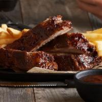 BBQ Baby Back Ribs · Our fall-off-the-bone ribs marinated, seasoned with spices, slow roasted, and finished over ...