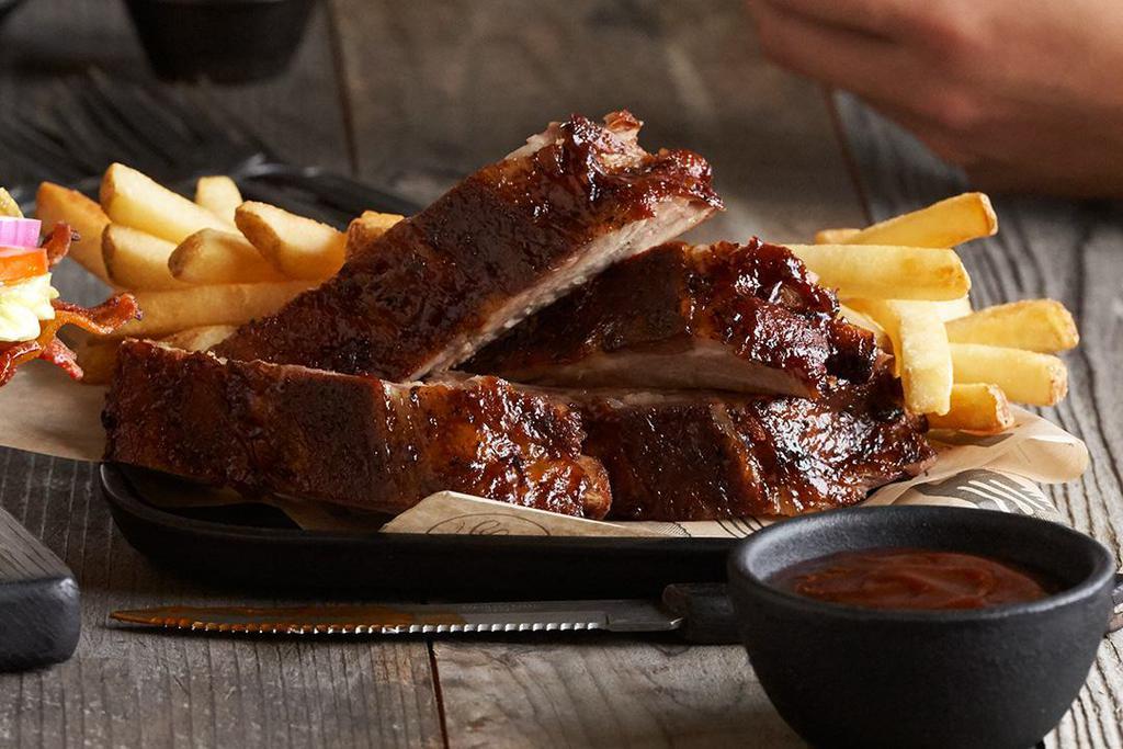 BBQ Baby Back Ribs · Our fall-off-the-bone ribs marinated, seasoned with spices, slow roasted, and finished over an open flame. Smothered in our smoky molasses bbq sauce.