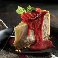 New York Style Cheesecake · Topped with sweet strawberry sauce.