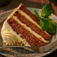 Spiced Carrot Cake · A slice of carrot cake with pineapple and walnuts, a dash of vanilla and cinnamon, layered t...