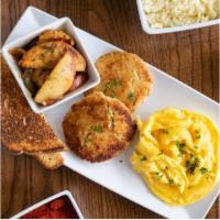 Salmon Croquettes · 2 pieces of croquette with choice of two eggs, rich creamy grits or breakfast potatoes, toas...