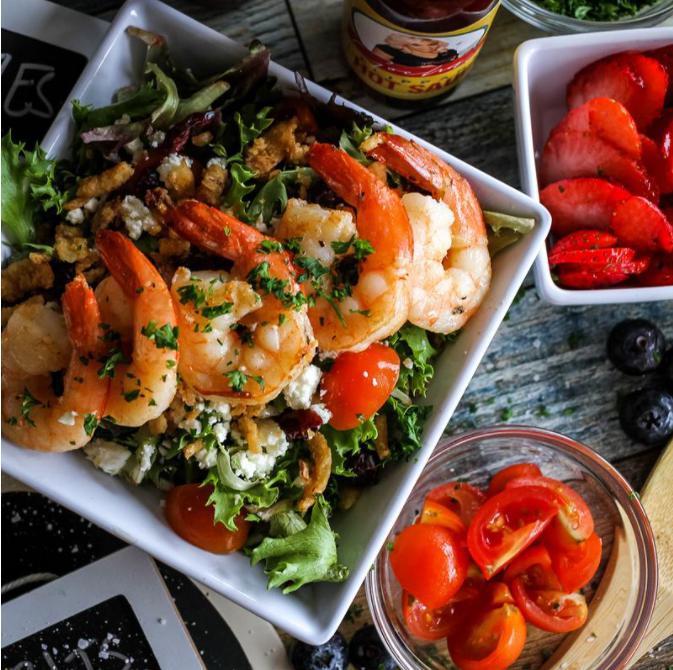 Fall Harvest Salad · Sitting on a bed of mixed greens served with feta cheese, dried cranberries, croutons, cherry tomatoes, fried onions served with sautéed shrimp.