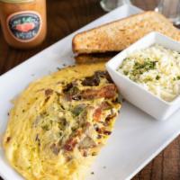 Meat Lover Omelette · Full of applewood pork bacon, chicken, pork sausage and white cheddar. Served with your choi...