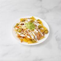 Santa Fe Nachos · Quartered corn tortilla chip with refried beans, melted cheddar and Monterrey cheese topped ...