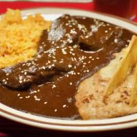 Chicken Mole · A mild sauce composed of chocolates, ground chile peppers and spices, served over breast of ...