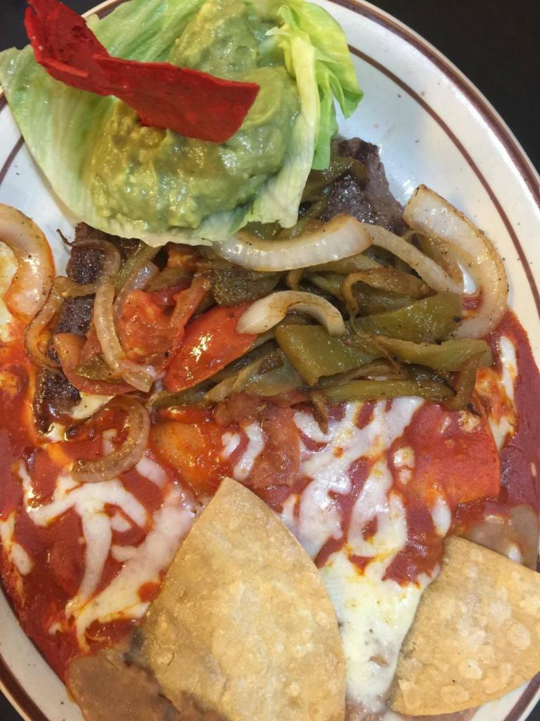17. Tampiquena Top Sirloin Steak · Grilled and smothered with strips of long green chile, tomatoes, onions, and served with 1 cheese enchilada, guacamole, refried beans and tortillas. Served with sopapillas with honey.