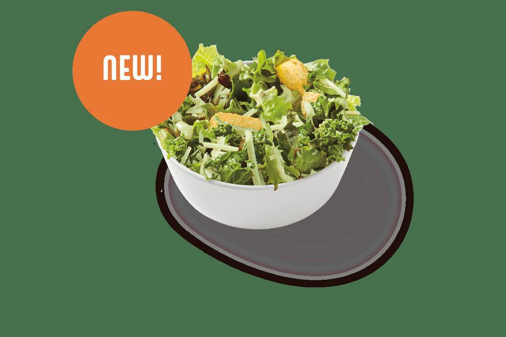 Caesar Side Salad · Tuscan greens and kale tossed in a Caesar dressing with garlic croutons and parmesan. | 210 Calories