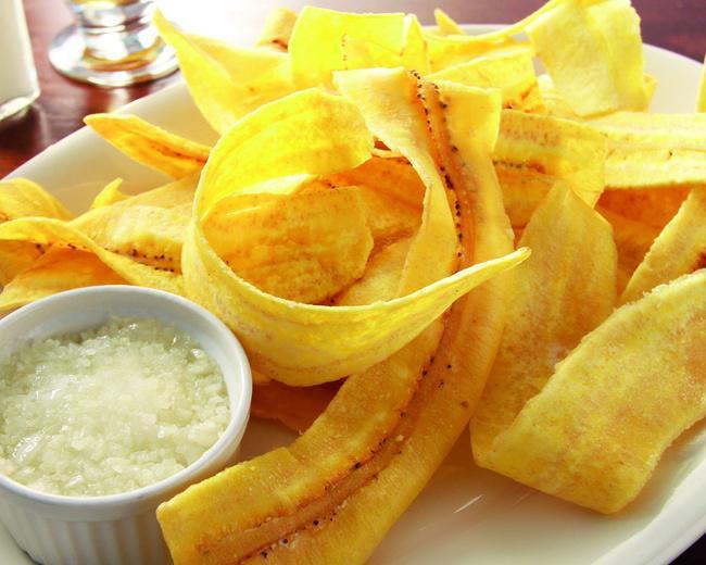 Mariquitas-Plantains Chips · Green plantains thinly sliced and fried, topped with mojito sauce (Garlic sauce).