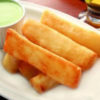 Yuca Frita- Fried Casava Root · Our Cuban potato, boiled, fried until golden crisp, served with garlic sauce.