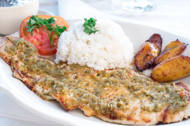 Chicken Chimichurri · Grilled chicken fillet covered with an exquisite chimichurri sauce. Served with white rice, black beans and sweet plantains.