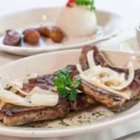 Pork Chops · Two sliced chops grilled served with chopped onions and parsley, white rice, black beans and...