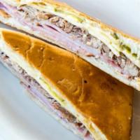Cuban Sandwich · Serrano ham, swiss cheese, pickles, roast pork and mayonnaise on a cuban bread crispy toasted.