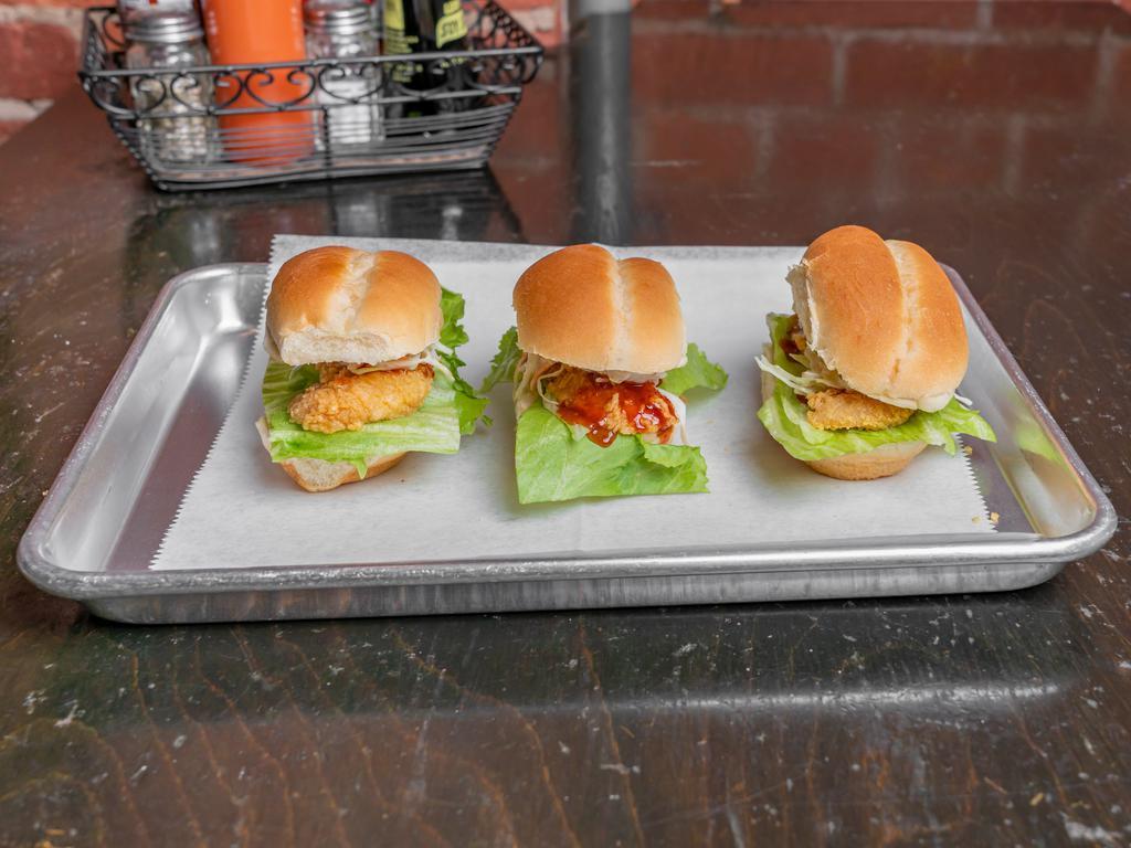 Chicken Sliders  · 3 garlic soy chicken sliders topped with coleslaw and lettuce.