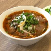 Bun Bo Hue Thit Bo Tai · Sliced thin rare filet mignon in spicy noodle soup.