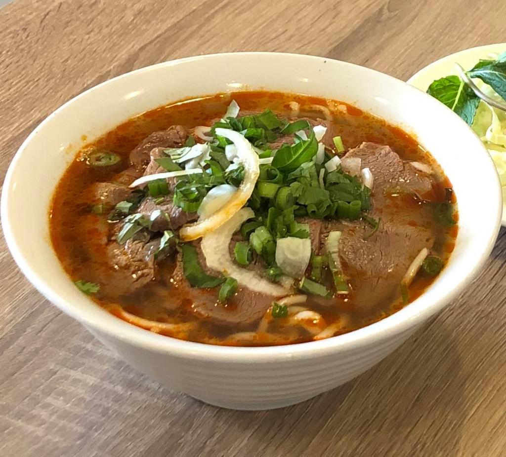 Bun Bo Hue Thit Bo Tai · Sliced thin rare filet mignon in spicy noodle soup.